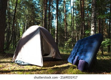 Sleeping accessories for comfortable tourist outdoor activities in the campsite. Tent with air mattress and pillow for sleeping outdoors