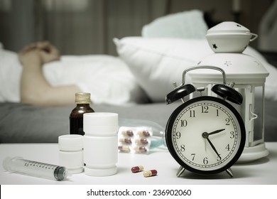 Sleeping Asian Man In Bed With Tablets And Drugs Suffering Insomnia, Hangover, Headache At Night