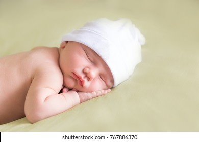 Sleeping Baby Boy Wearing A White Hat