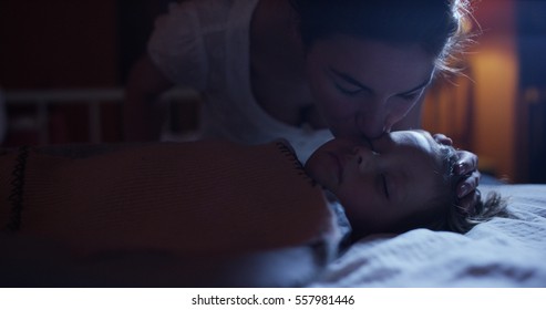 Sleeping Baby Happy And Carefree, Mother  Gives A Kiss For A Goodnight. Concept Of House And Home. Night And Happy Dreams, No Mosquitoes, No Noisy Home And Comfortable Mattresses. Comfortable Children