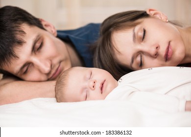 Sleeping Baby With Mom And Dad, Closeup