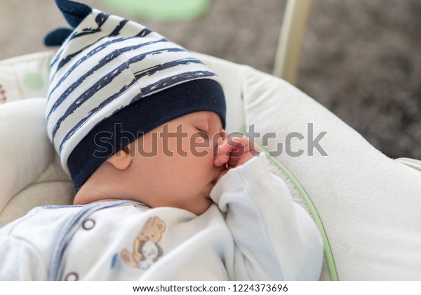 baby sleeping in swing chair