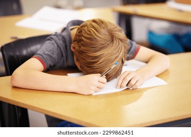 Sleeping, bored and tired with boy in classroom for learning, education and knowledge. Stress, anxiety or confused with male student at desk in school adhd for exhausted, autism problem or frustrated - Powered by Shutterstock