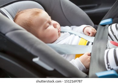 Sleeping Caucasian Baby Buckled Into Rear-facing Car Seat, Close Up View