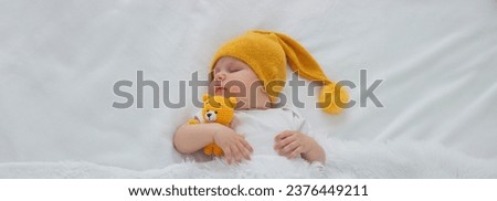 Sleeping child in bed holding teddy bear. Selective focus