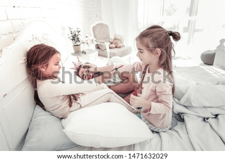 Similar – child girl playing checkers with her dad at home