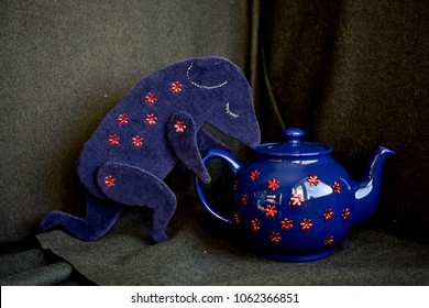 Sleeping Dormouse With A Large Blue Teapot.