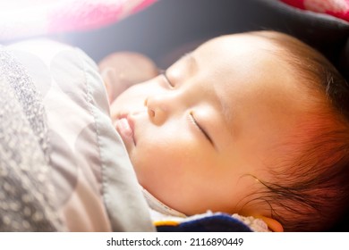 Sleeping Face Of Cute 0 Years Old Baby With Shallow Depth Of Field With Natural Light.