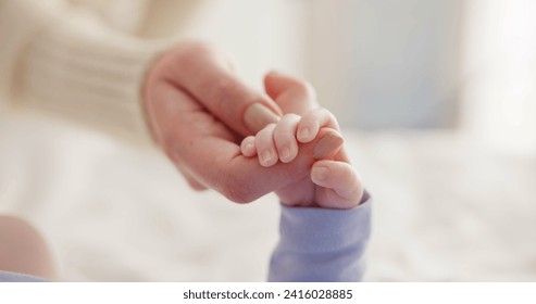 Sleeping, family and holding hands with baby on bed for bonding, love and relationship with infant. Adorable, care and closeup of parent with newborn for support, dreaming and protection at home - Powered by Shutterstock