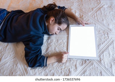 Sleeping girl lying in bed with a turned on tablet - Powered by Shutterstock