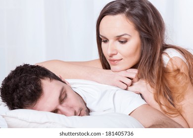 Sleeping Man And Pretty Awake Woman In Bed