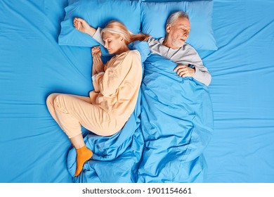 Sleeping married family couple have deep sleep at night enjoys serene atmosphere dressed in nightwear. Mature woman and man take nap after hard working day feel comfortable. Bedtime concept. - Powered by Shutterstock