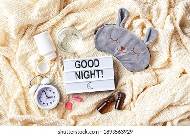 Sleeping Mask, Alarm Clock, Earplugs, Essential Oils And Pills. Healthy Night Sleep Creative Concept. Flat Lay, Top View. Good Night, Sleep Hygiene, Insomnia