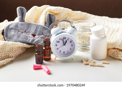 Sleeping Mask, Alarm Clock, Earplugs, Essential Oils And Pills. Healthy Night Sleep Creative Concept. Good Night, Sleep Hygiene, Insomnia