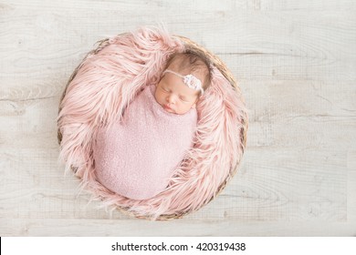 Sleeping Newborn Baby In A Basket