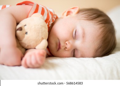 Sleeping Newborn Baby On With A Teddy