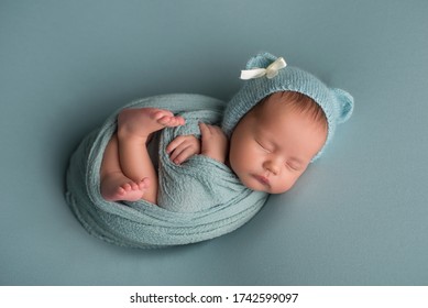 sleeping newborn baby in a wrap - Shutterstock ID 1742599097