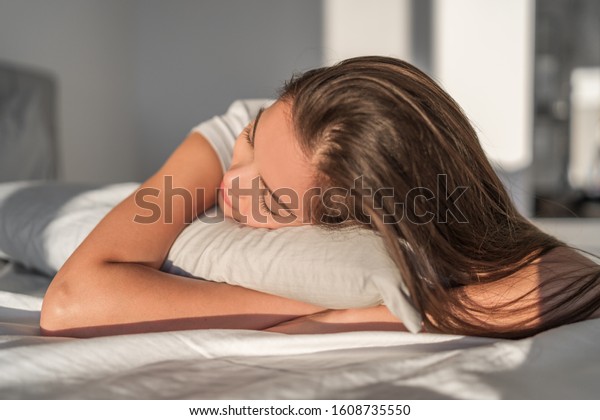 Sleeping on foam pillow bed Asian girl\
sleeping on stomach sleeper resting head on foam pillow. Hair care\
silk pillowcase. Good night sleep or midday\
nap.