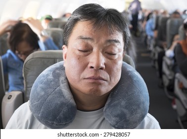 Sleeping On The Plane With A Neck Pillow On Vacation