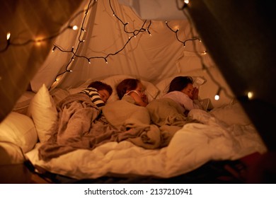 Sleeping in our imaginary tent. Shot of three young children sleeping in blanket tent. - Powered by Shutterstock