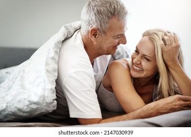 Sleeping in over the weekend is one of lifes great pleasures. Shot of an affectionate couple spending the day in bed. - Powered by Shutterstock