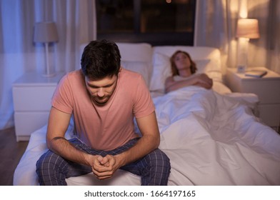 Sleeping, Rest And People Concept - Sad Man With Insomnia Sitting On Bed At Home At Night