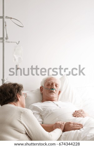 Female doctor comforting older female patient