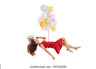 Sleeping Vietnamese woman lifted up by bunch of balloons, isolated on white