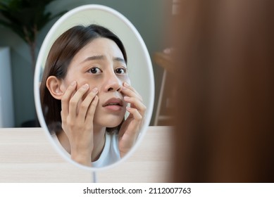 Sleepless Asian Woman Looking Her Face In The Mirror And Worry About Dark Circles Under Eyes