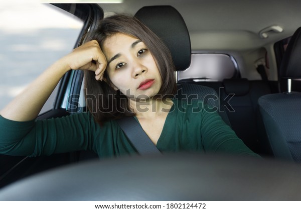 sleepless Asian woman tired and sleepy during driving\
car 