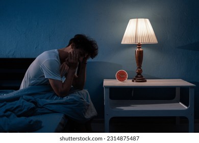 Sleepless, man suffering from insomnia, sleep apnea or stress. Tired and exhausted guy. Headache or migraine. Awake in the night. Frustrated person with problem. Copy space - Shutterstock ID 2314875487