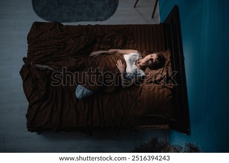 Similar – a girl with her hair by her face lying on the bed