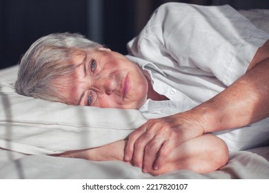 Sleepless middle-aged woman lying in bed suffers from insomnia sleep disorder cant sleep till morning, depressed elderly female looking upset thinking about life, health troubles concept - Powered by Shutterstock