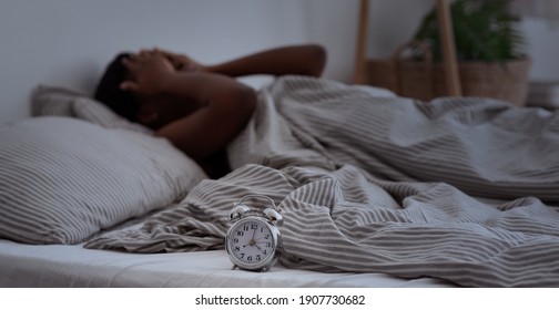 Sleepless, Woman Suffering From Insomnia, Sleep Apnea Or Stress, Headache Or Migraine. Tired And Exhausted African American Lady Awake In Middle Of Night, Near Alarm Clock With Time In Dark, Panorama