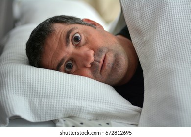 Sleeplessness Man Suffering From Insomnia Sleep Disorder Awake In Bed. Real People. Copy Space.