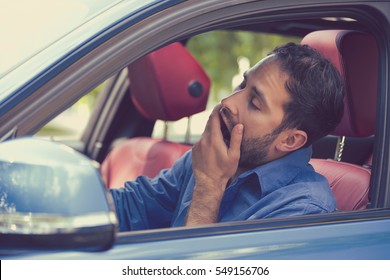 Sleepy Fatigued Yawning Exhausted Young Man Driving His Car In Traffic After Long Hour Drive. Transportation Sleep Deprivation Accident Concept