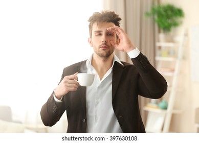 Sleepy Guy Holding A Cup Of Coffee.