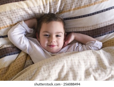 Sleepy Happy Child Lying In A Bed, Waking Up In The Morning.