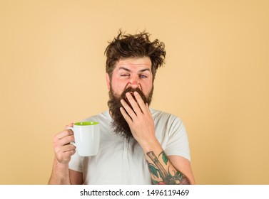 Sleepy Man Holds Cup Of Coffee. Yawning Man Holds Mug With Hot Drink.Man With Cup Of Fresh Coffee. Tired Guy Hold Coffee Mug. Morning Refreshment. Man With Sleepy Face Try To Awake With Cup Of Coffee.