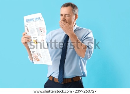 Sleepy mature journalist with newspaper on blue background