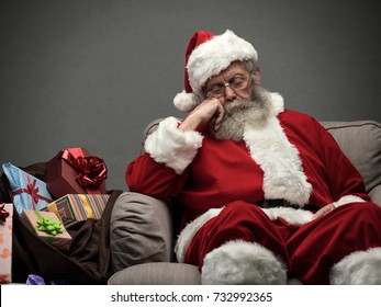 Sleepy Santa Claus taking a nap and relaxing on the armchair on Christmas Eve - Powered by Shutterstock