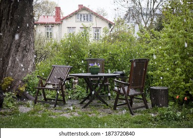 Sleet Falling On Garden Furniture And Plants In Spring 