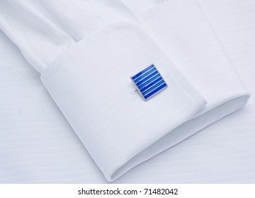 Sleeve Of A White Shirt With A Dark Blue Cuff Link Close Up