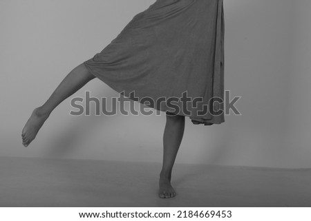Slender barefoot female legs in black and white
