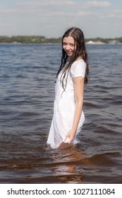 Slender Girl In White Wet Dress In Water