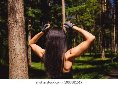 Slender nice brunette in sports uniforms practicing fitness in the forest in summer
 - Shutterstock ID 1088381519