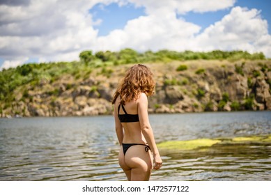 Slender Woman In A Bikini Back View, Free Space. Beautiful Landscape.