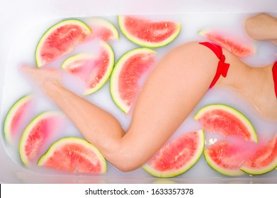 A Slender Woman Takes A Milk Bath With Slices Of Watermelons. SPA Skin Care Treatments. Girl In A Red Bikini. Red Lipstick. Likes In The Jacuzzi. Cleopatra Rejuvenation. View From Above. Beautiful