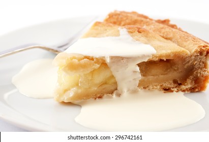 A Slice Of Apple Pie On A Plate With Cream On Top