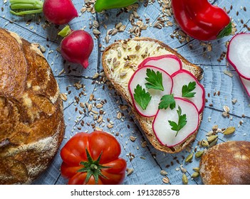 Slice Of Artisan Bread With Cream Cheese, Radish, Butter Decorated With Parsley And Seeds . Homemade Bread From Sourdough